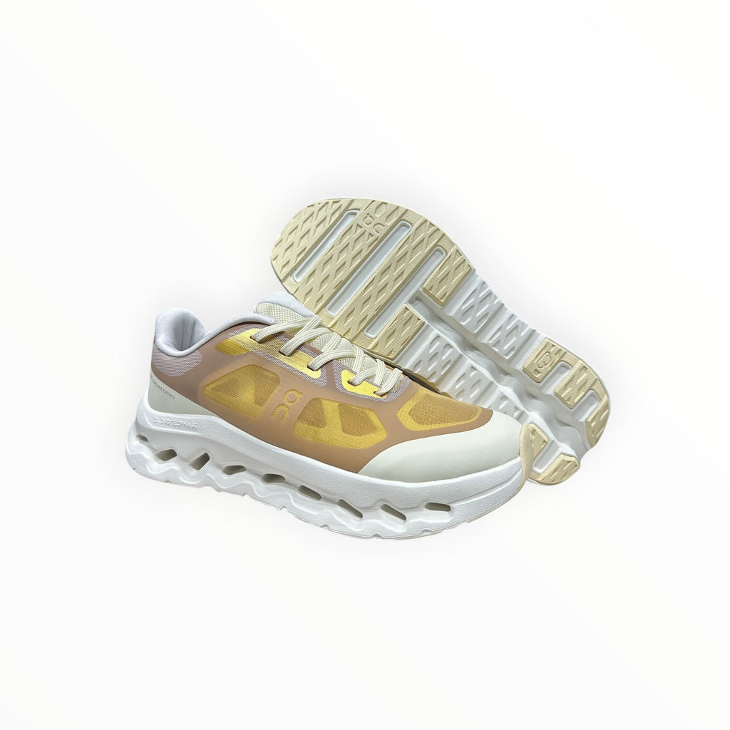 EWW Sports Shoes On Cloudtilt Remix gold and white sneakers with a layered, see-through upper and white chunky sole.