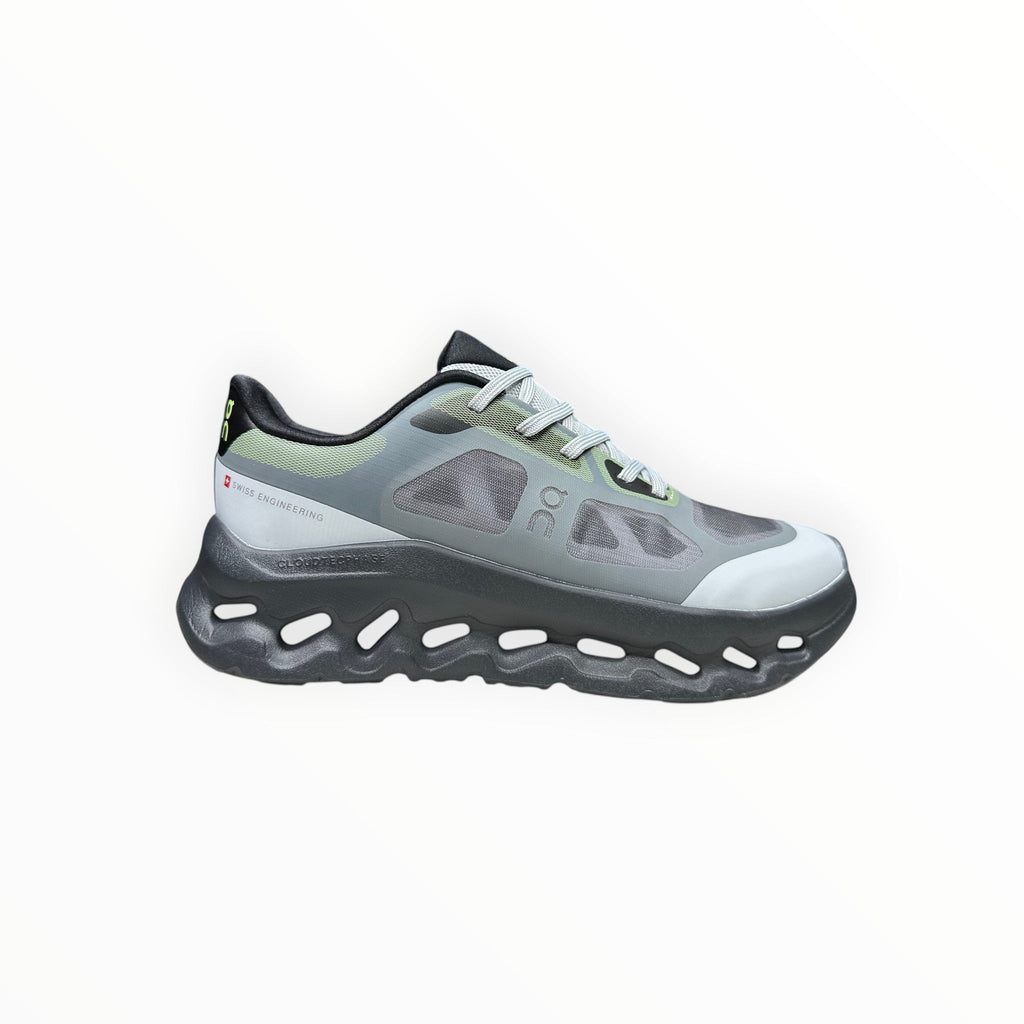 EWW Sports Shoes On Cloudtilt Remix grey and black running shoe with see-through upper and chunky sole.